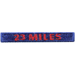 The words 23 Miles are stitched in red on a dark blue rectangle.