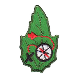 A compass with a red dotted line connected to it and an X on a green leaf.