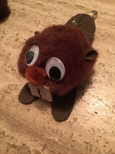 A beaver made from a pompom with googly eyes.