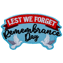 Two doves beneath the words Lest We Forget Remembrance Day.