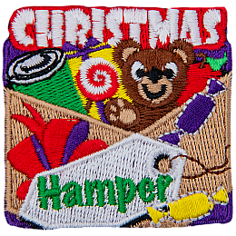 The words Christmas Hamper around some toys and candy. 