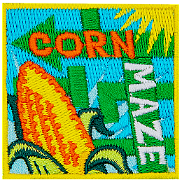 An ear of corn next to the words Corn Maze.
