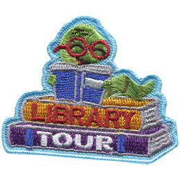 A book worm reads a book on top of two books on this adorable patch.