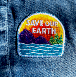 E-Patches & Crests Save Our Earth patch on denim jeans.