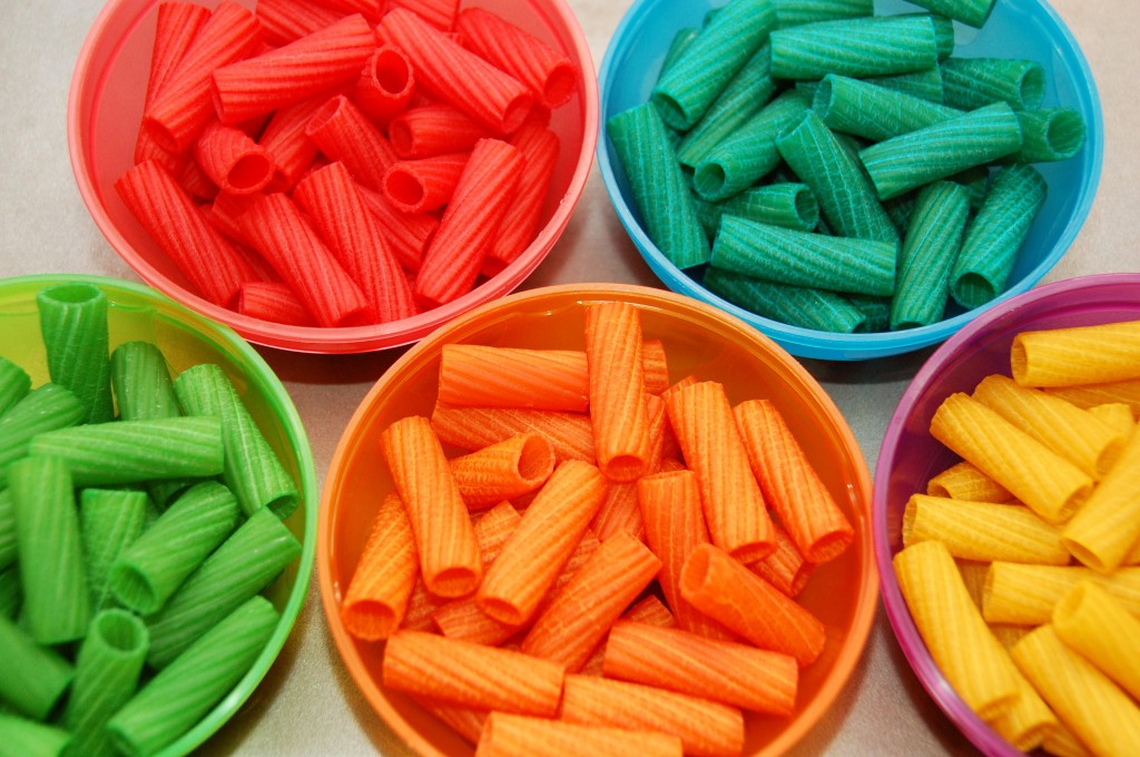 Bowls of coloured pasta.